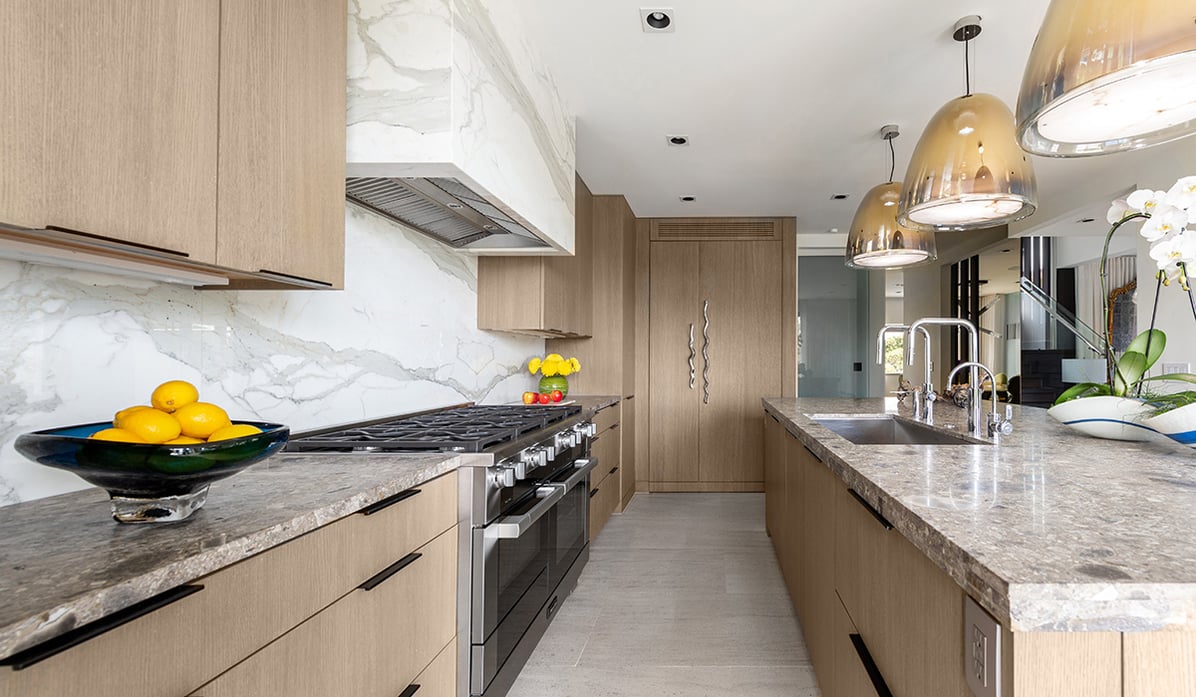 kitchen with wood cabinetry and marble counters